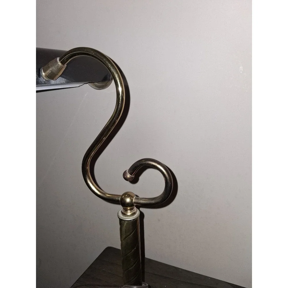 Vintage brass tone desk lamp with elegant scroll arm and classic piano light